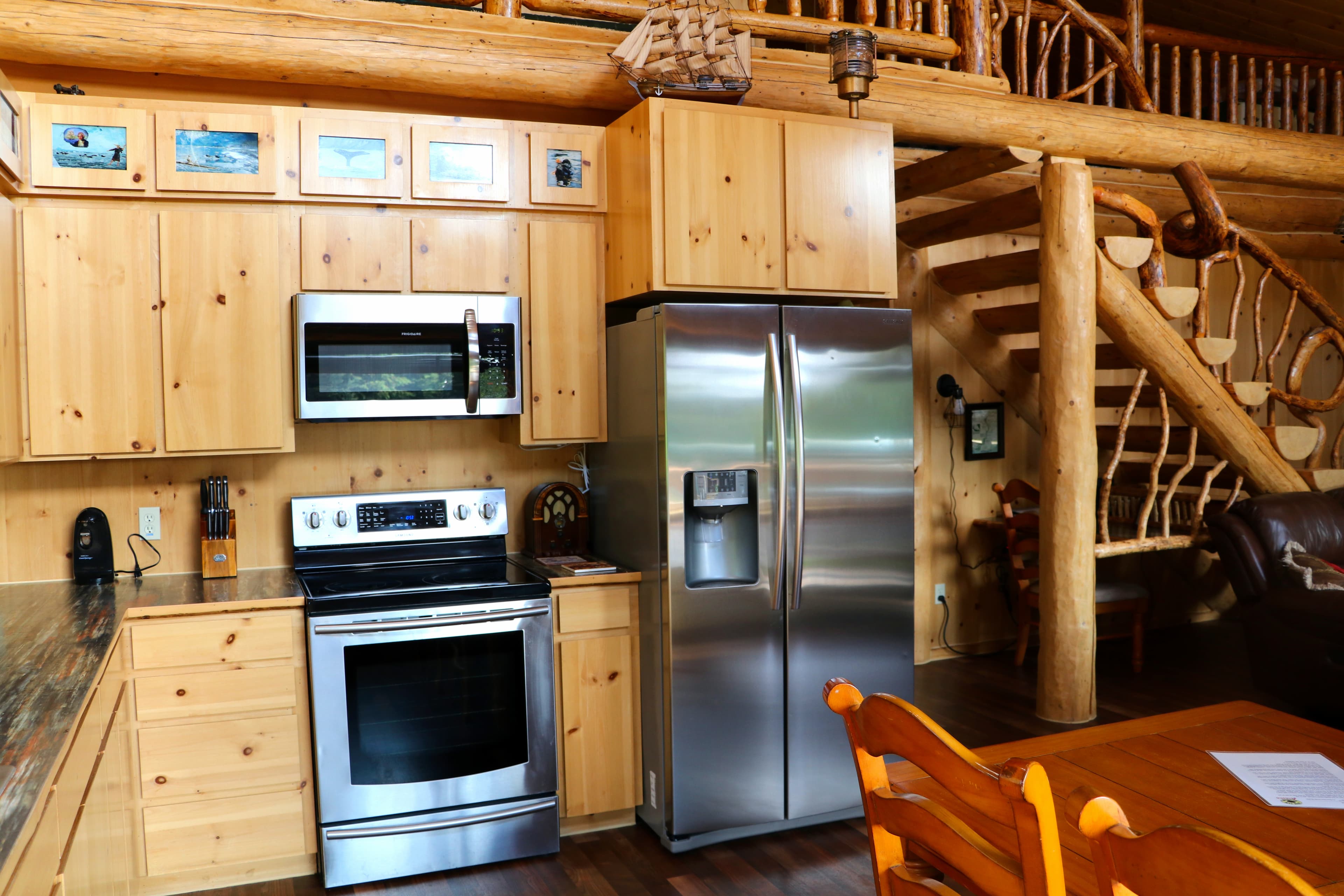 Kitchen with stainless steel appliances including an oven, microwave, and refrigerator.