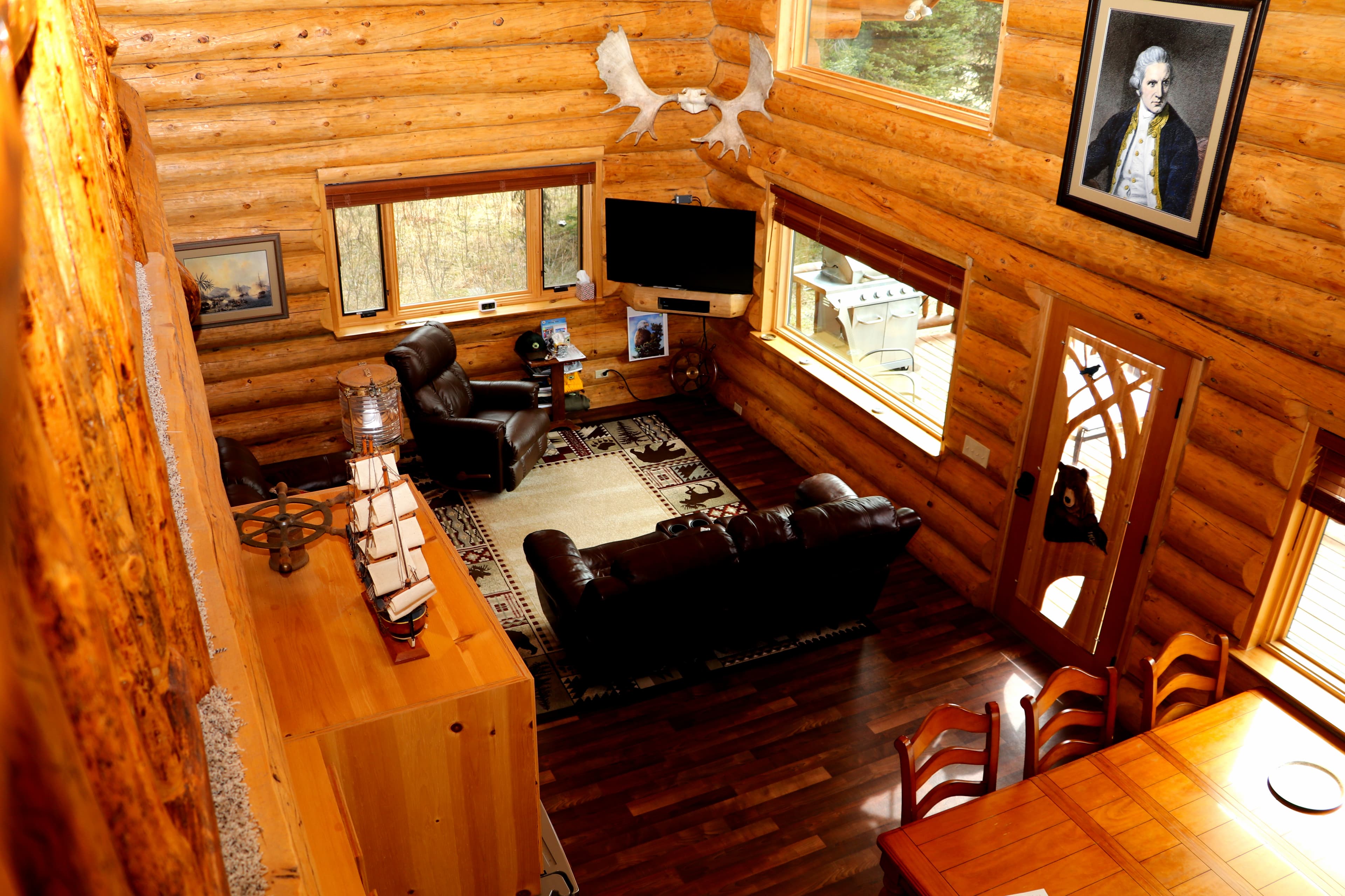 Bird's eye view of Den from Loft showing spacious first floor with comfortable sitting area and dining area.