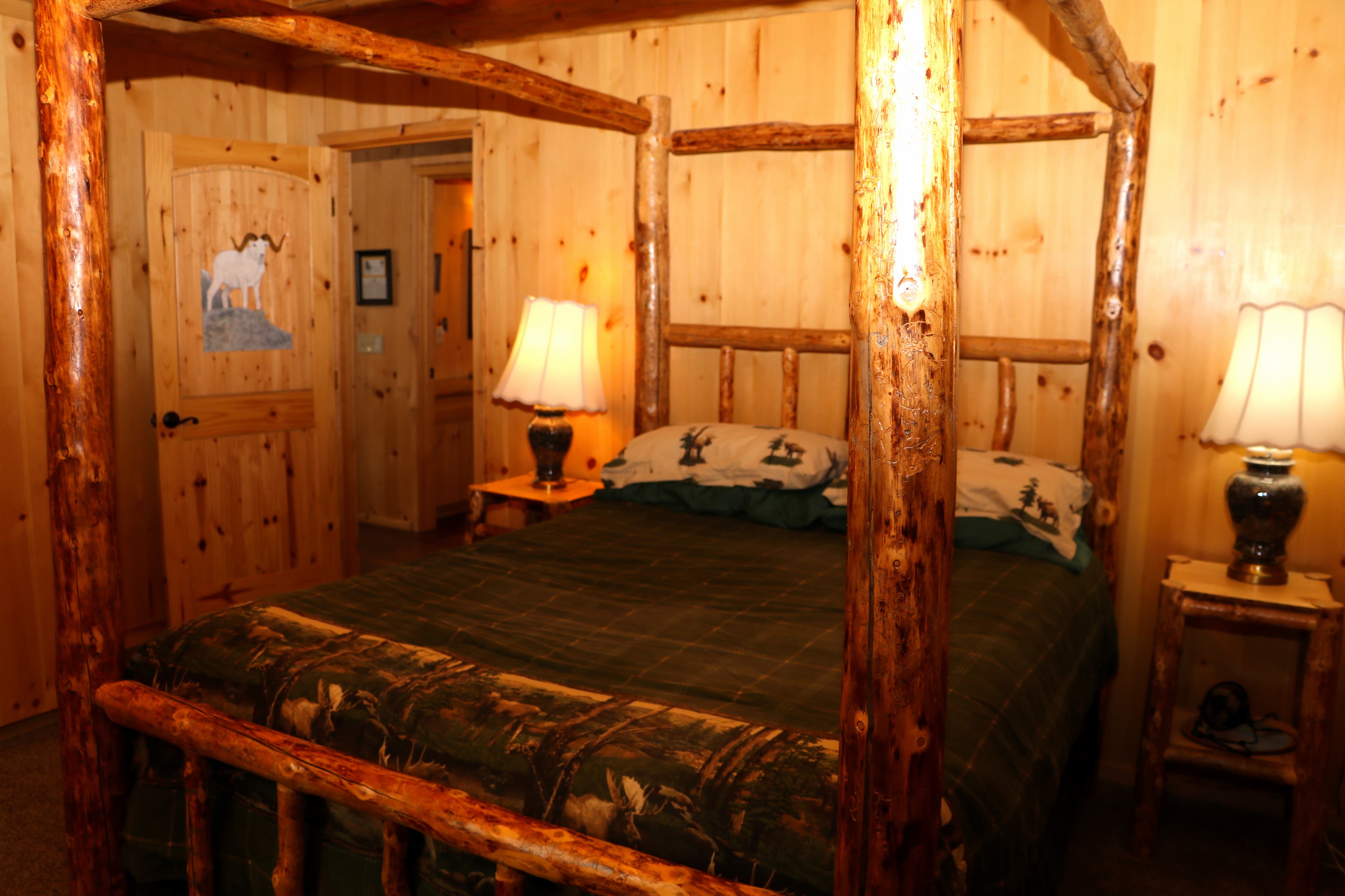First Floor Queen Four-poster Bed constructed from rough-hewn logs.