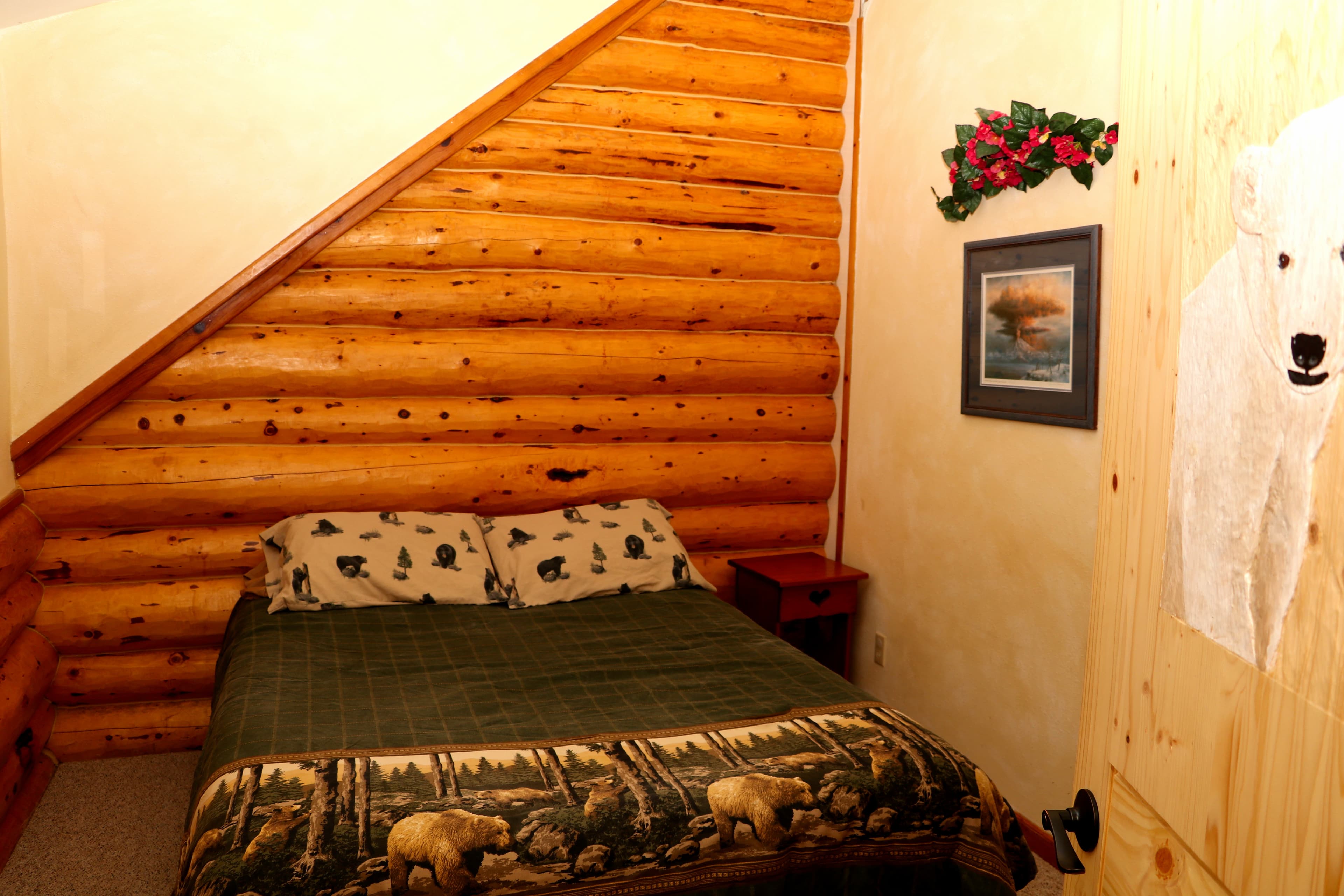 2nd Floor Queen Bedroom with hand-painted polar bear on natural wood door.