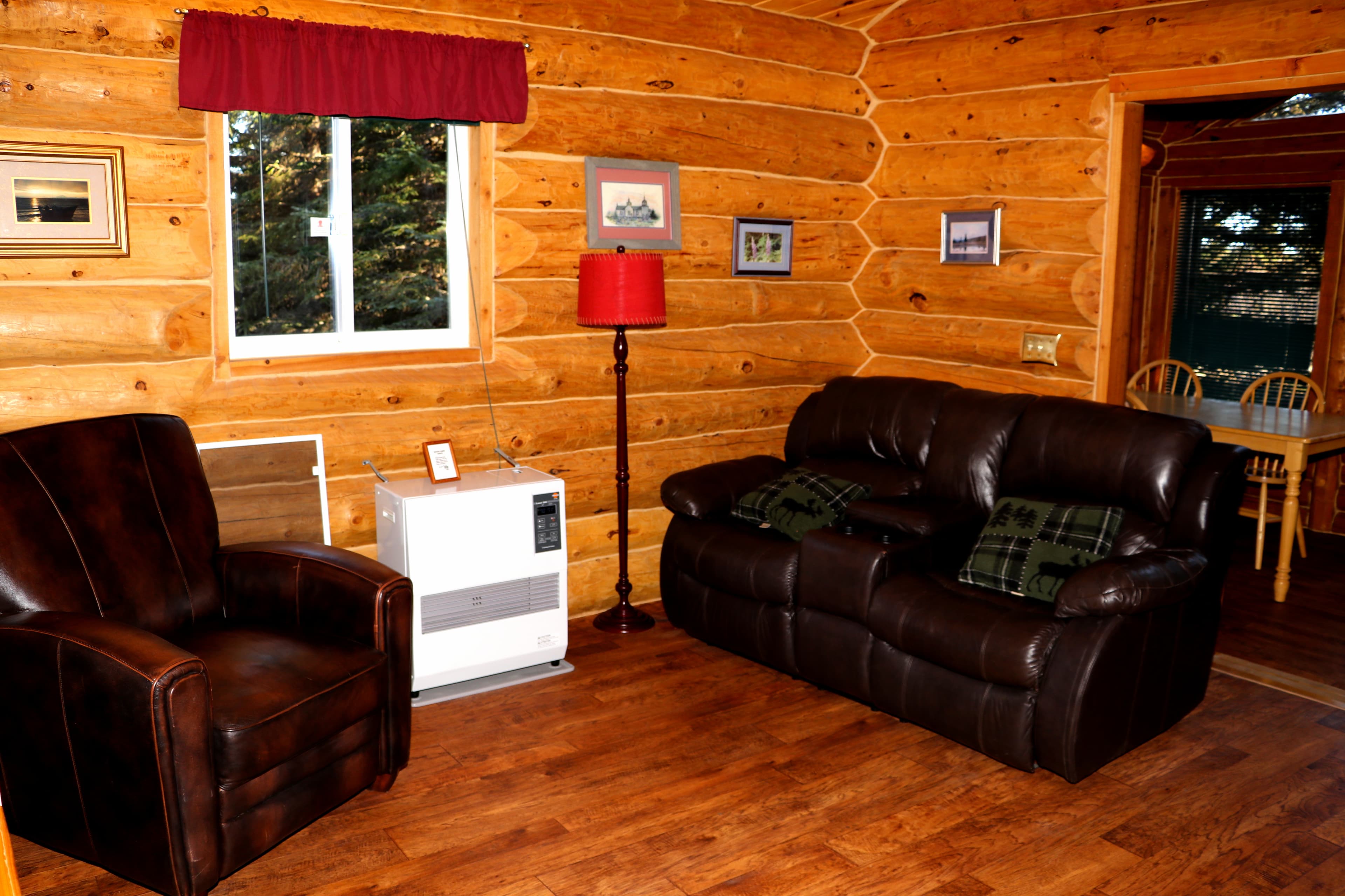Sitting area with brown leather recliner and loveseat.
