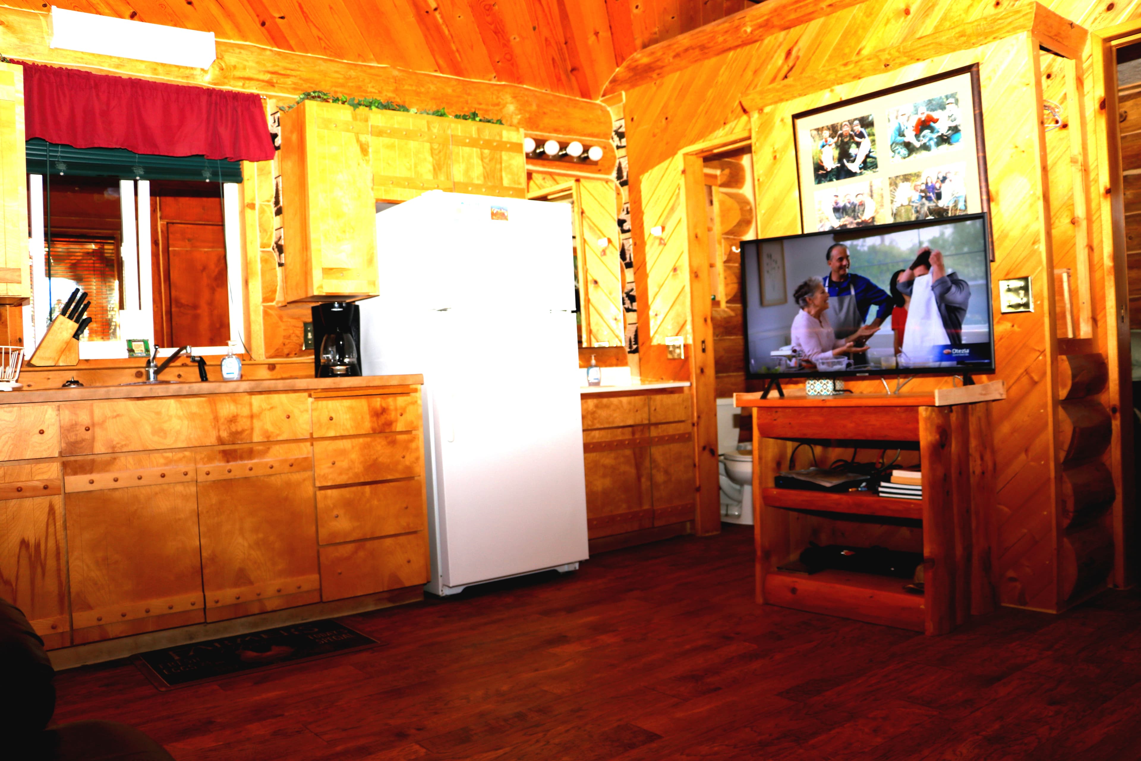 A cozy log cabin with open kitchen and living area.