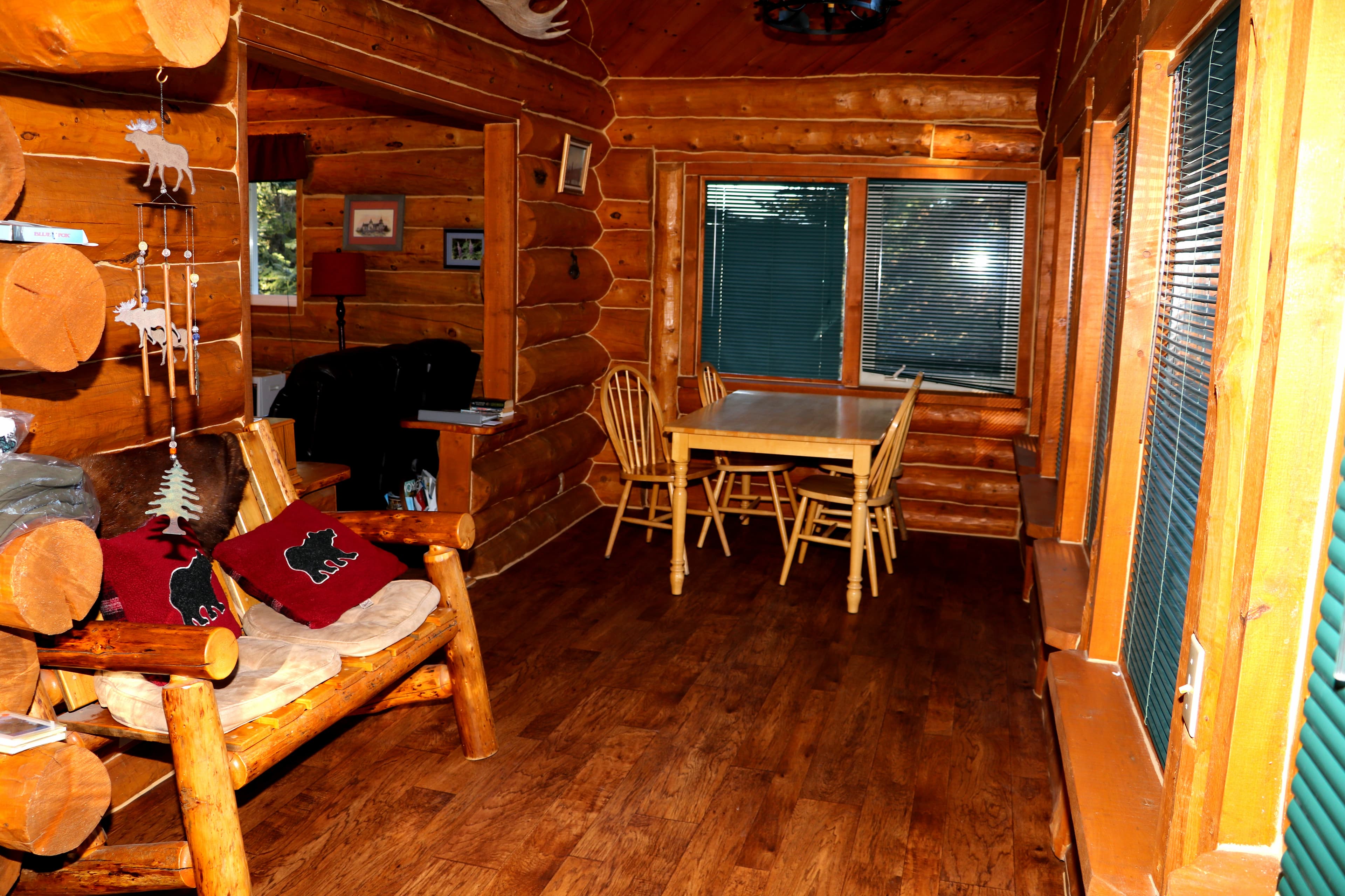 Dining area with wooden table and chairs.