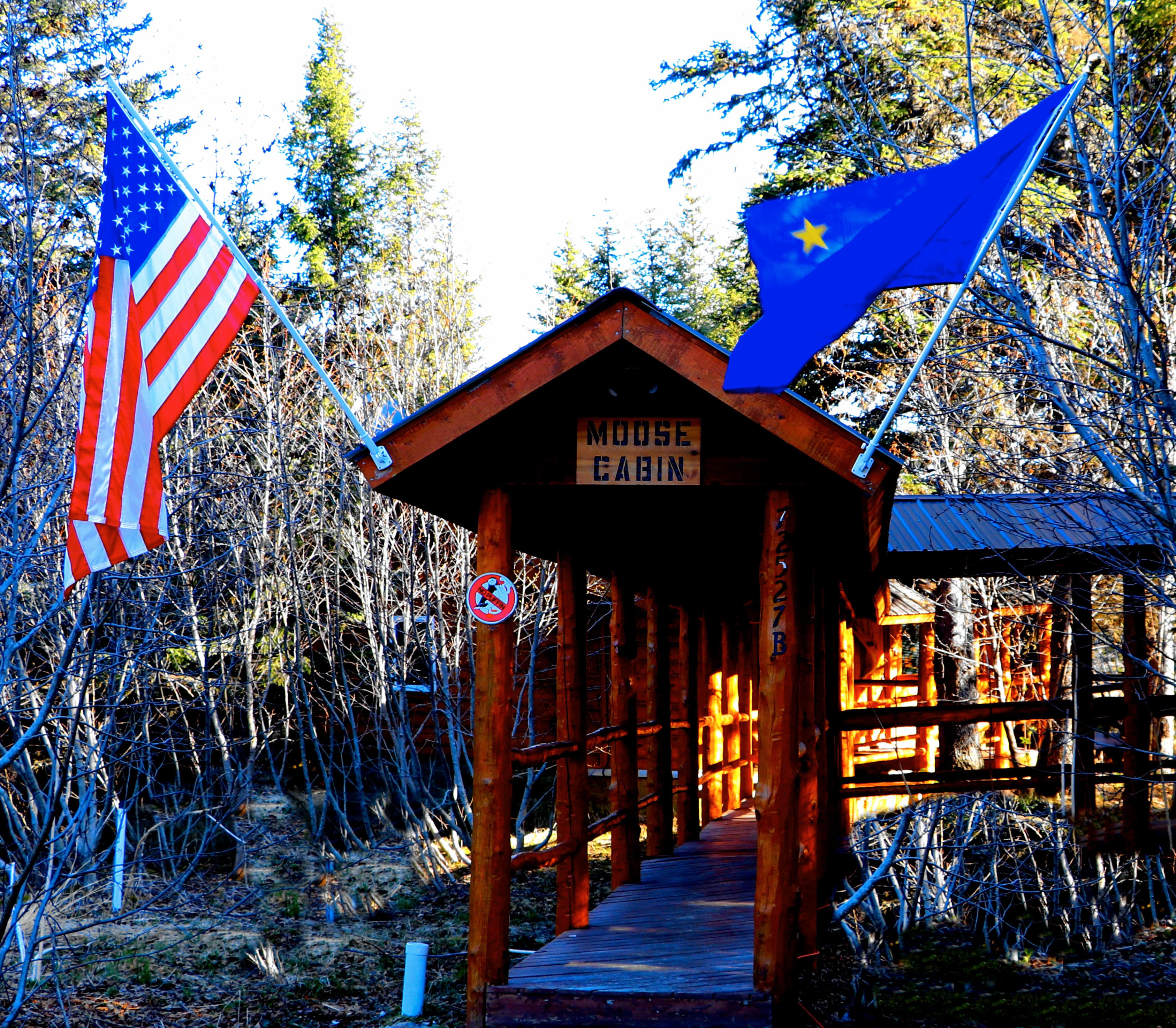 The covered wooden walkway leading to the entrance of Moose Cabin.